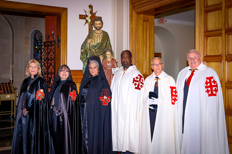 Members of the Miami chapter of the Equestrian Order of the Holy Sepulcher pose in front of a statue of St. Joseph at St. Mary Cathedral in Miami before the closing Mass of the 2025 Jubilee Year Dec. 27, 2025.