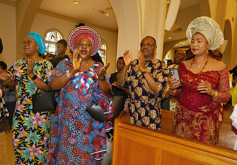 Members of the Nigerian apostolate enjoy Nigerian music at the end of the annual Migration Mass celebrated by Archbishop Thomas Wenski Jan. 11, 2026, the feast of the Baptism of the Lord, at St. Mary Cathedral.