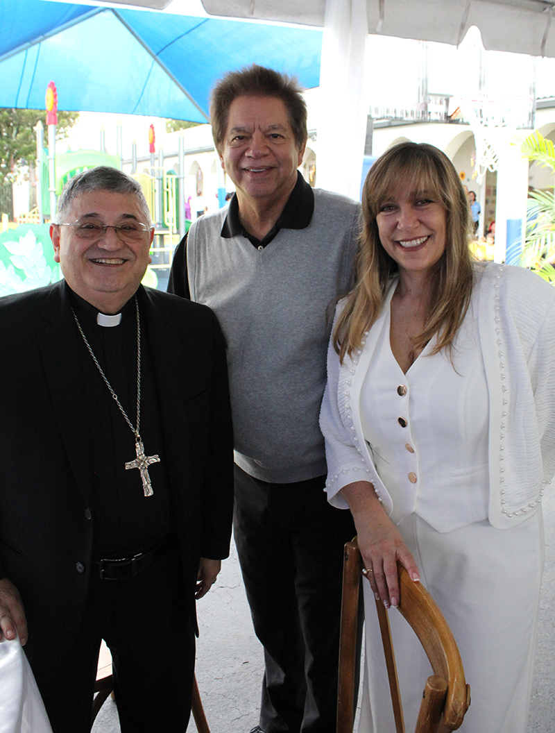 Miami Auxiliary Bishop Enrique Delgado joins Peter Routsis-Arroyo, Chief Executive Officer of Catholic Charities, and Julietta Riveron, Centro Mater West Program Administrator, during the 30th anniversary of Centro Mater West at their location in Hialeah Gardens, Jan. 14, 2026.