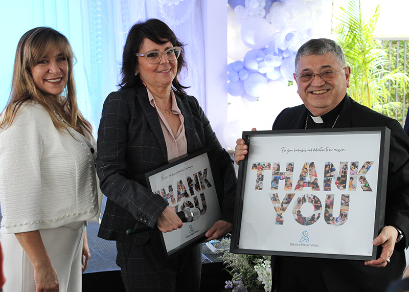 Julietta Riveron, Centro Mater West Program Administrator, and Madelyn Llanes, Centro Mater Executive Director, present Miami Auxiliary Bishop Enrique Delgado with a token of appreciation during the Centro Mater West Child Care Center's 30th anniversary celebration on Jan. 14, 2026.