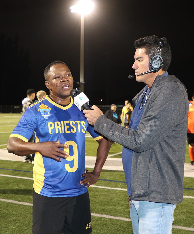 A Radio Paz commentator interviews Father Reynol Brevil, parochial vicar at St. Mary Cathedral in Miami, who scored the only goal for the priests’ team after the game. The seminarians defeated the priest 7-1 in the fourth Archbishop's Cup played at St. Thomas University in Miami Gardens, Jan. 16, 2026.