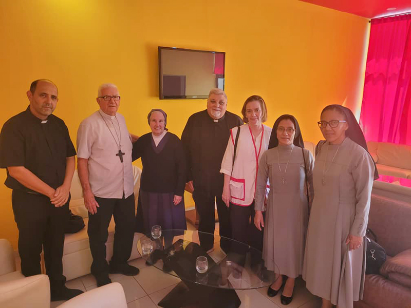 Representatives of the Archdiocese of Miami accompanied a shipment of humanitarian aid to Santiago de Cuba Jan. 28, 2026, and were welcomed by Cuban priests and nuns. In the photo, from left, Father Rogelio Deán Puerta, rector of the Basilica Shrine of Our Lady of Charity in El Cobre; Msgr. Dionisio García Ibáñez, archbishop of Santiago de Cuba and president of Caritas Cuba; Sister Eva Pérez-Puelles, of the Daughters of Charity in Miami; Father José Espino, rector of the National Shrine of Our Lady of Charity in Miami; Ana María Piñol Navarrete, director of Caritas Santiago de Cuba; and two religious sisters in Cuba.