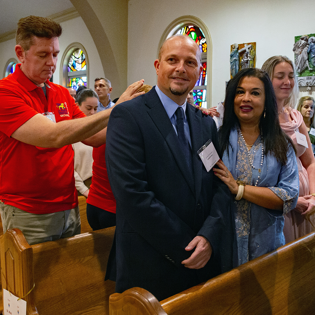 FEBRUARY 22, 2026Marlene Quaroni/FCSponsor, Marcella Dickinson, places her hand on her husbands shoulder and catechumen Caine Dickinson of St. Marks Church. Michael Moscatello, One of three OCIA program leaders, also places his hand on the catechumen947 catechumens from 110 parishes signed the Book of the Elect during two ceremonies at St. Mary's Cathedral