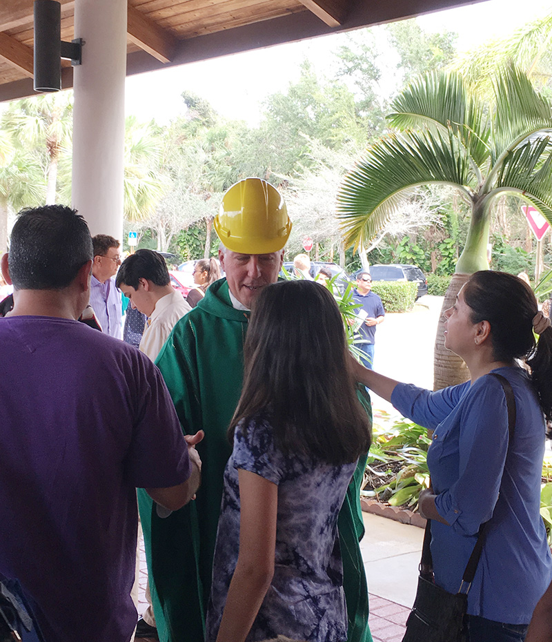 Father John Peloso greets parishioners after Sunday Mass at St. Edward's Church, where he was pastor during a renovation project.