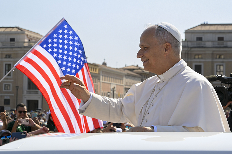 With a U.S. flag in the background, Pope Leo XIV waves to the crowd from the popemobile as he rides around St. Peter's Square at the Vatican before his weekly general audience Aug. 6, 2025. Pope Leo named Archbishop Caccia as the new papal nuncio to the United States March 7, 2026. He succeeds Cardinal Christophe Pierre, who turned 80 in January and had served in the post since 2016.