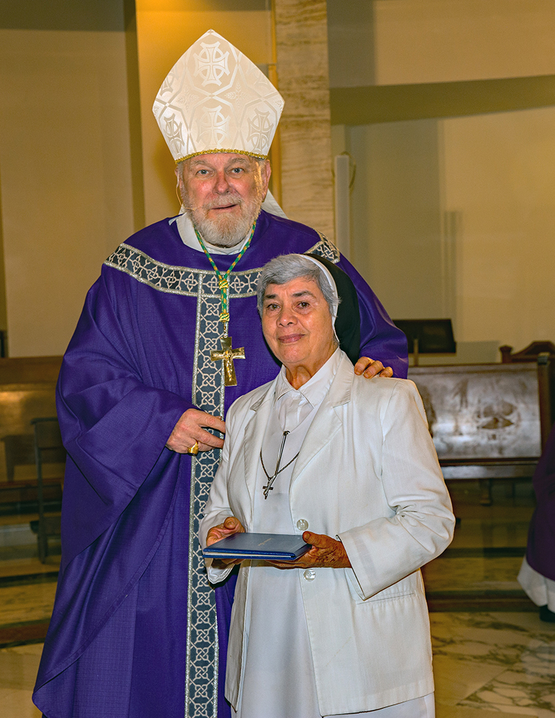 Archbishop Thomas Wenski gives certificate to Sister Blanca Hernandez, OP, for 50 years. Archbishop Thomas Wenski celebrated Mass for Archdiocese of Miami consecrated life members and four jubilarians Mar. 8, 2026.