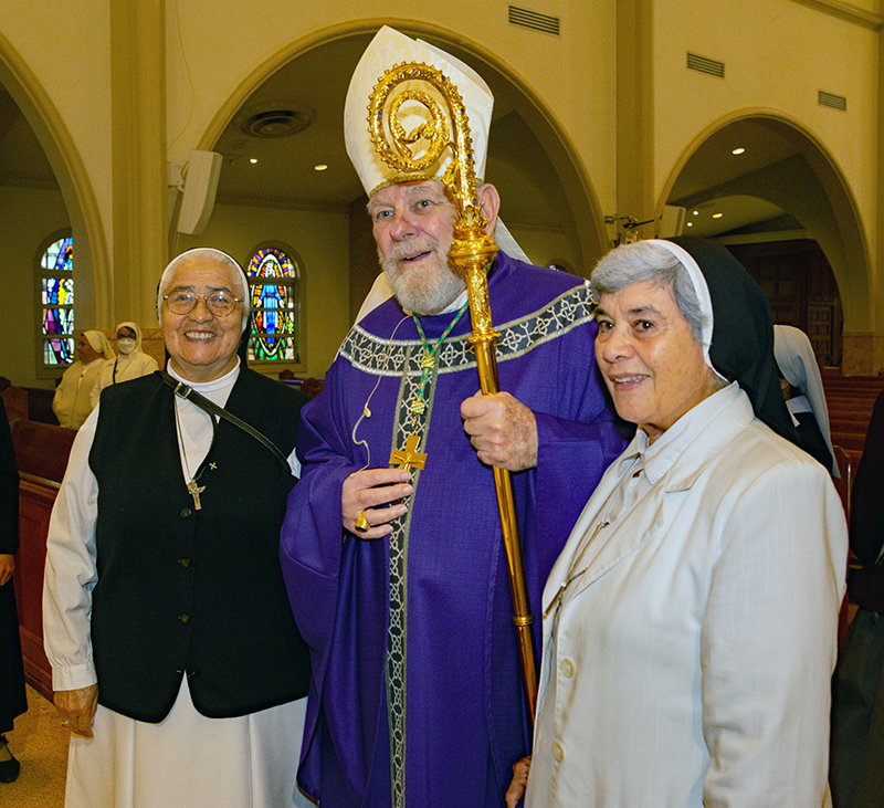 Archbishop Thomas Wenski poses for a photo with Sister Emith Montero and Sister Saleh Abed Alnour, FMA, 25 year honoree. Archbishop Thomas Wenski celebrated Mass for Archdiocese of Miami consecrated life members and four jubilarians Mar 8, 2026