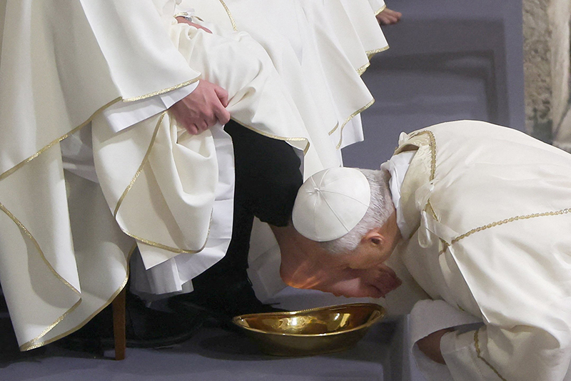 Pope Leo XVI kisses the foot of a clergyman after washing it as he celebrates the Holy Thursday Mass of the Lord's Supper in the Basilica of St. John Lateran at Vatican April 2, 2026. (OSV News photo/Vincenzo Livieri, Reuters)