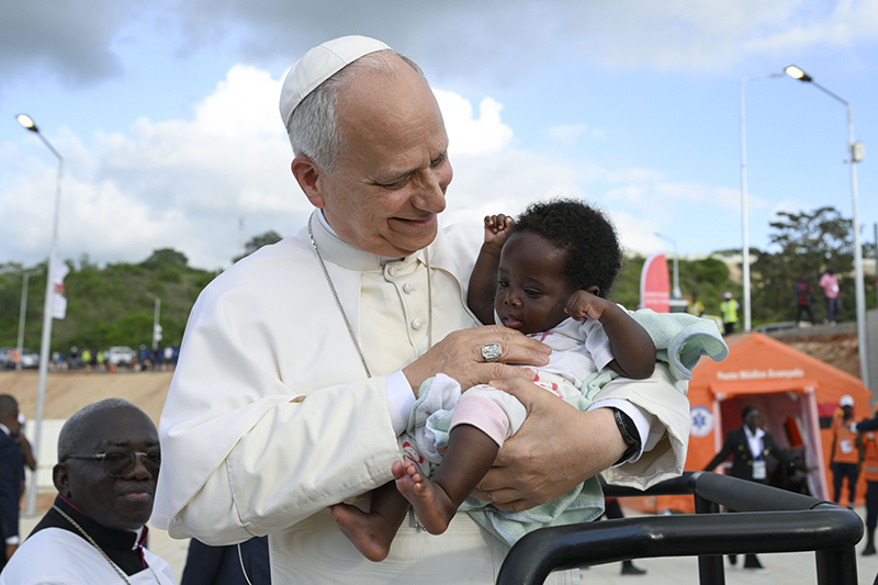 Pope Leo XIV holds a baby at the Sanctuary of Our Lady of Muxima in Muxima, Angola, April 19, 2026. (OSV News photo/Simone Risoluti, Vatican Media)