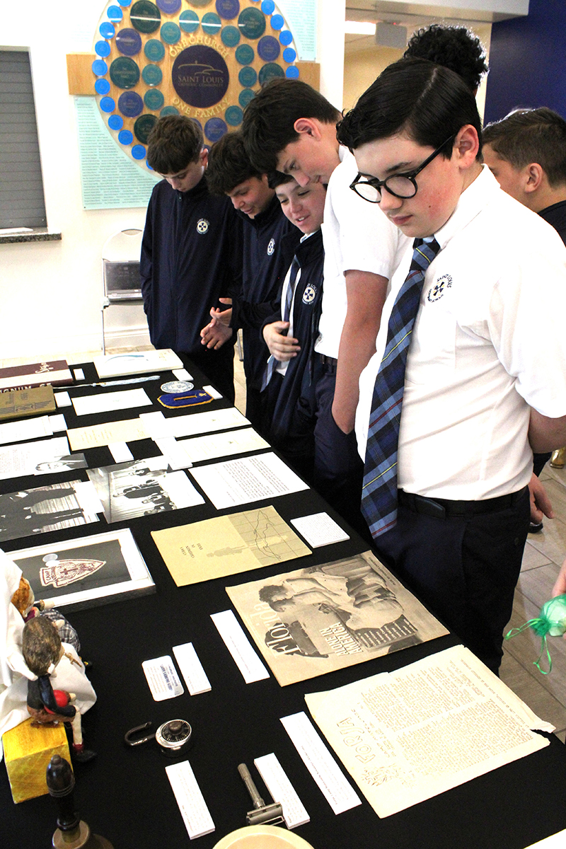 St. Louis Covenant School students look at artefacts during the "Childhood in Exile: Operation Pedro Pan 2026" showcase, curated and hosted at St. Louis on March 16, 2026.