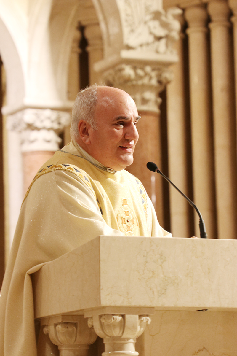 Father Roberto Cid, pastor of St. Patrick Church in Miami Beach, talks to his parishioners at the end of the Mass commemorating the 100th anniversary of the parish on St. Patrick’s Day, March 17, 2026.