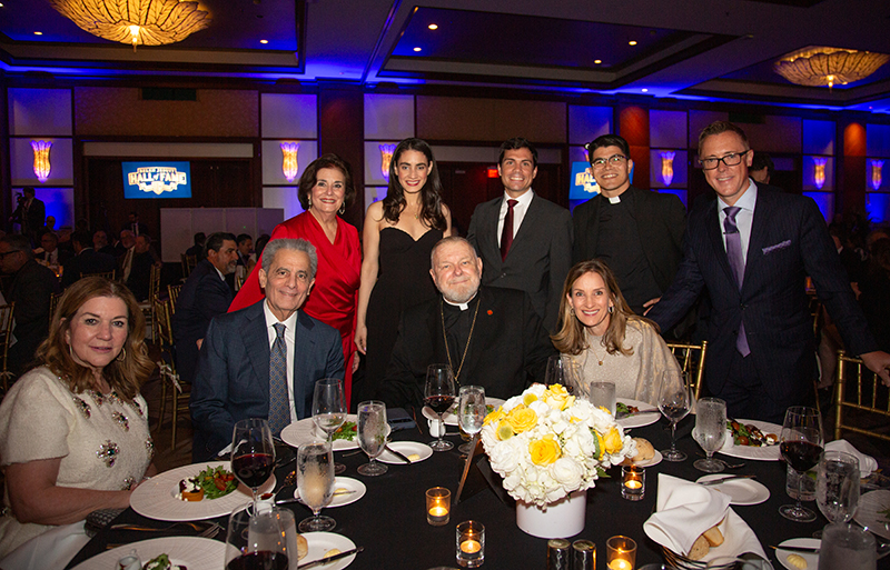 Archbishop Thomas Wenski, center poses for a photo with several guest at the Belen Jesuit Preparatory School Hall of Fame induction ceremony March 21, 2026 at the InterContinental Hotel in Miami. With him are front left, Conchi Argiz, Tony Argoz, and Katie Blanco, president of the Archdiocese's Development Corporation, and, top row from left, Beatriz Pereira, Jeanette and Dito Mas, Fr. Agustin Estrada and Matt Bourdeau.