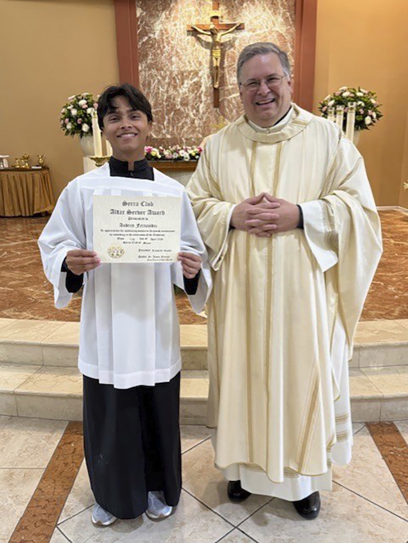 Andres Fernandez poses with his certificate alongside Father Jesus Ferras of St. Kieran Church. The Altar Servers Awards Mass was celebrated at St. John Vianney College Seminary in Miami on April 11, 2026.