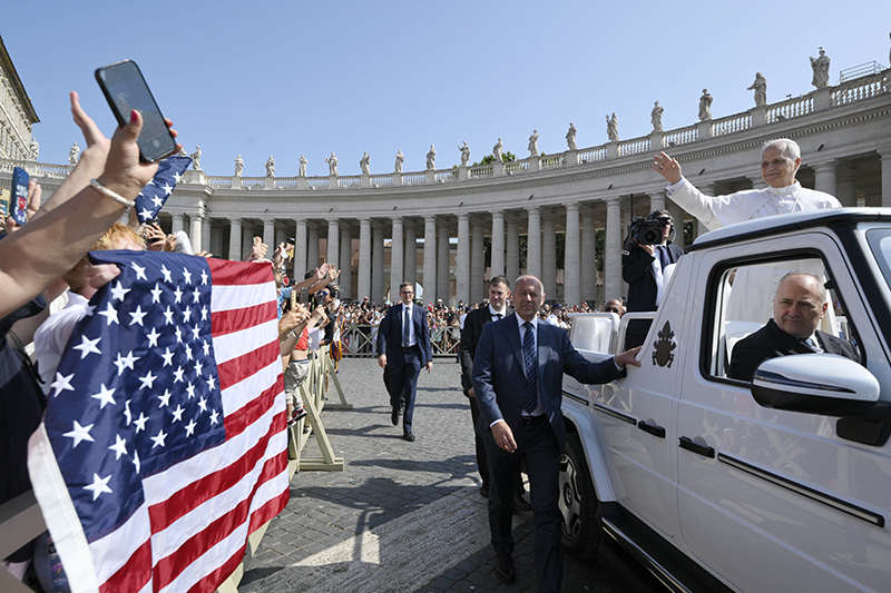 Pope Leo XIV waves to pilgrims holding a flag of the United States as he arrives in St. Peter's Square on the popemobile for his general audience at the Vatican June 18, 2025. The Vatican press office confirmed Feb. 8, 2026, that Pope Leo XIV has no plans to visit the U.S. this year. (CNS photo/Vatican Media)