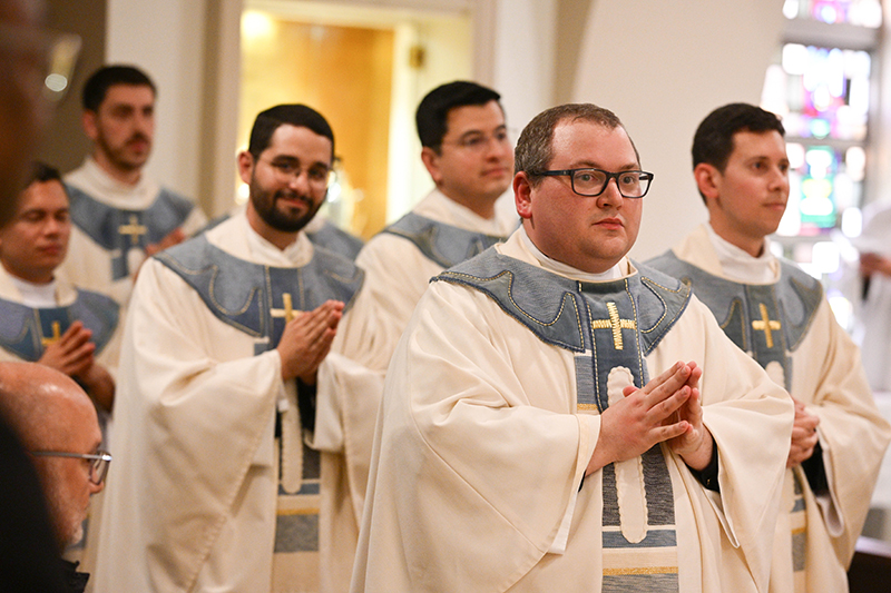 After washing their hands following an anointing, the nine newly ordained priests of the Archdiocese of Miami prepare to return to the altar, where Miami Archbishop Thomas Wenski will present each with a chalice.
