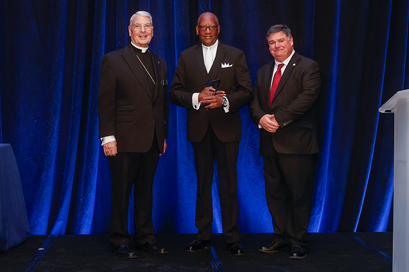 April 6, 2026Minneapolis, MNAfter receiving the 2026 National Catholic Educational Association (NCEA) Lifetime Commitment to Catholic Education Award, Donald Edwards, Archdiocese of Miami associate superintendent of schools, posed with Archbishop Gregory Hartmayer, OFM Conv., archbishop of Atlanta and chair of the Board of NCEA, and Steven Cheeseman, NCEA president and CEO. The presentation took place April 6, 2026 at the NCEA Convention and Expo in Minneapolis, Minnesota.