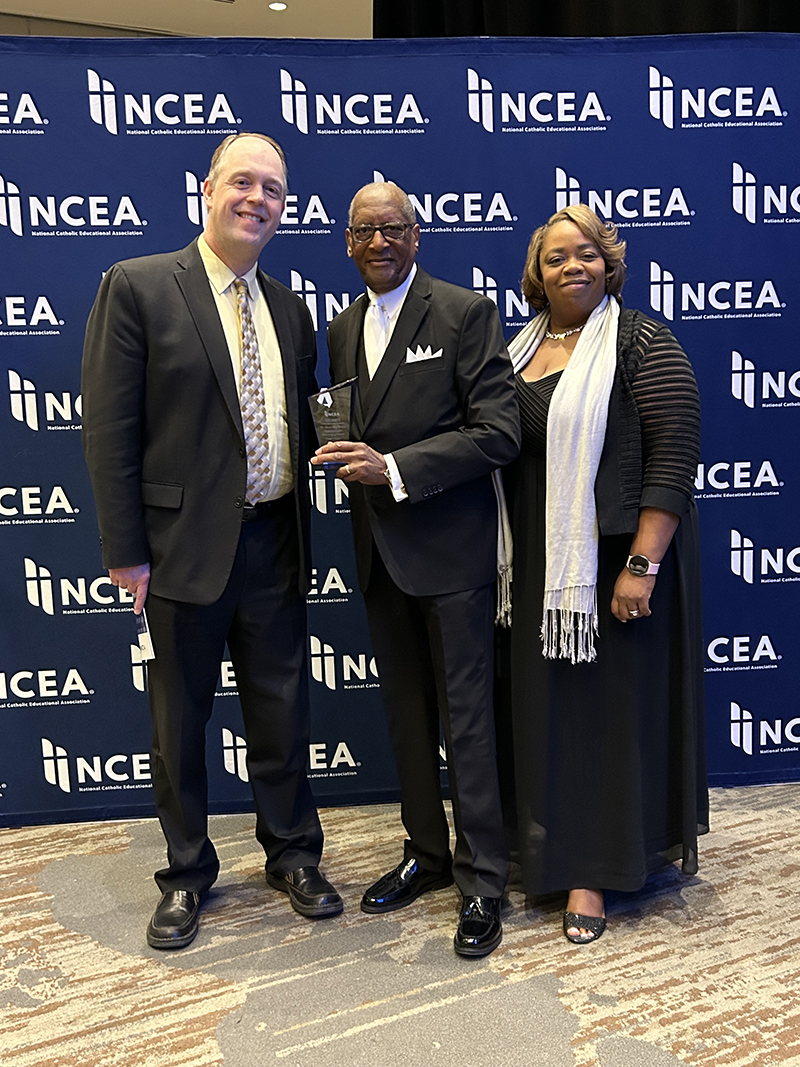 April 6, 2026Minneapolis, MNJim Rigg, Archdiocese of Miami superintendent of Catholic Schools, and LaTonya White, associate superintendent of  teaching and learning, pose with their colleague, Donald Edwards, associate superintendent, who received the 2026 National Catholic Educational Association (NCEA) Lifetime Commitment to Catholic Education Award. The educators traveled in April 2026 to the NCEA Convention and Expo in Minneapolis, Minnesota, where Edwards was presented with the award.