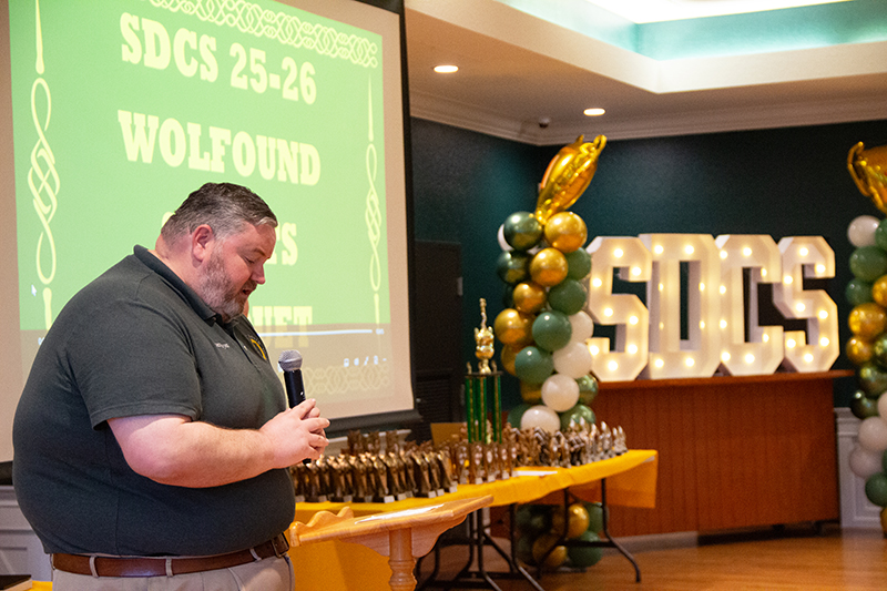 Father Ryan Saunders, pastor of St. David Parish and School in Davie, prays at the school’s inaugural sports awards ceremony May 29, 2026. The event took place in the parish hall and honored over 120 student athletes.
