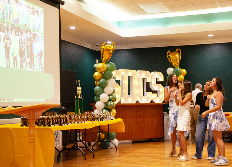 A group of girls enjoys watching season highlights during St. David School’s inaugural sports awards ceremony May 29, 2026. The event, honoring over 120 student athletes for their performance during the 2025-2026 season, took place in St. David’s parish hall in Davie.