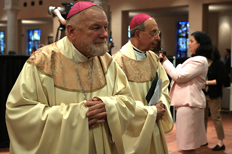 Archbishop Thomas Wenski of Miami, left, and Archbishop William E. Lori of Baltimore, right participate in the June 11 Mass at the Basilica of the National Shrine of Mary, Queen of the Universe in Orlando. During the liturgy, U.S. bishops consecrated the United States to the Sacred Heart of Jesus.