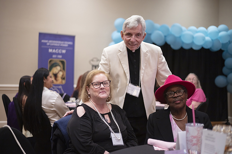 Father Michael Greer, spiritual advisor to the Miami Archdiocesan Council of Catholic Women, greets attendees during the organization's 68th Annual Convention in Miami.