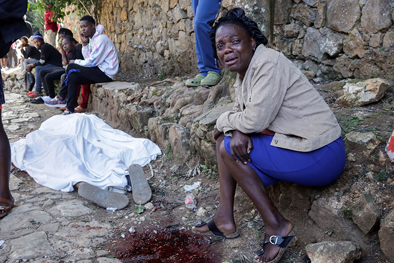 A woman mourns next to the covered body of a person in Kenscoff, Haiti, on the outskirts of Port-au-Prince, Aug. 24, 2026, killed after a fatal overnight raid by an armed gang. A powerful gang coalition attacked a once peaceful farming community nestled in the hills above Haiti’s capital late Aug. 23, killing at least 47 and kidnapping 50. (OSV News photo/Fildor Pq Egeder, Reuters)