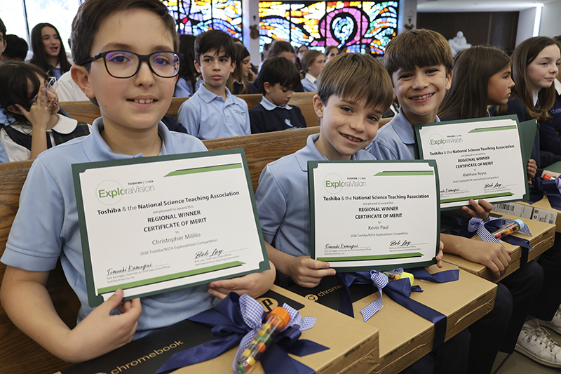 St. Thomas the Apostle School third-graders Christopher Millilo, Kevin Paul and Matthew Reyes proudly hold their K-3 category regional winner certificates from the 2026 Toshiba/NSTA ExploraVision Competition. During the 2025-2026 school year, the team made regionals in the largest K-12 science competition in the world for their invention idea, the “SpitBit,” a device they envisioned as analyzing saliva for signs of health problems.