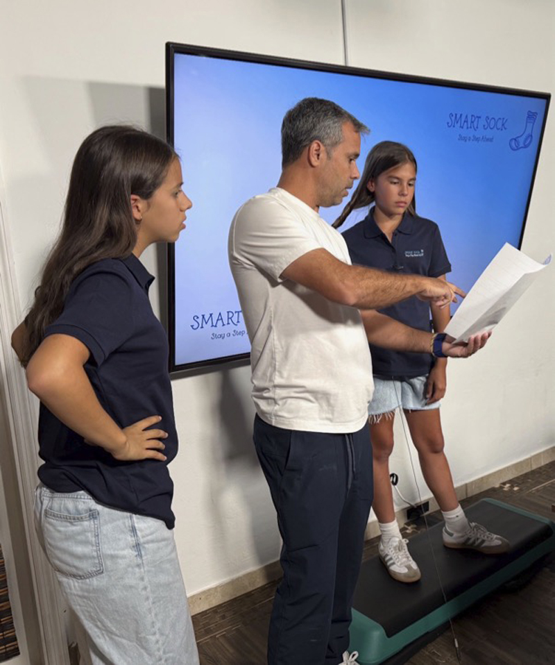 St. Thomas the Apostle School students Clementina Martinez-Christensen (far left) and Sam Dominguez (far right) receive tips on video recording from Clementina’s dad, Sebastian Martinez-Christensen. In the 2026 Toshiba/NSTA ExploraVision Competition, the largest K-12 science competition in the world, the girls and their teammate Adriana Icaza won second place in the Grade 4-6 category for their “Smart Sock” invention idea.