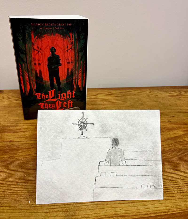 A piece of fan art for Sister Allison Regina Gliot’s Catholic vampire trilogy is displayed along with Book Two, “The Light They Left.” Gliot received the art from a teenage girl who shared, ‘When I finished the book, I was so happy that I danced around my room! But more importantly, I want you to know that it not only provided enjoyment, but also a deeper understanding in our Lord's love and mercy... It helps me remember that God loves me so much and that love inspires me to do good things."