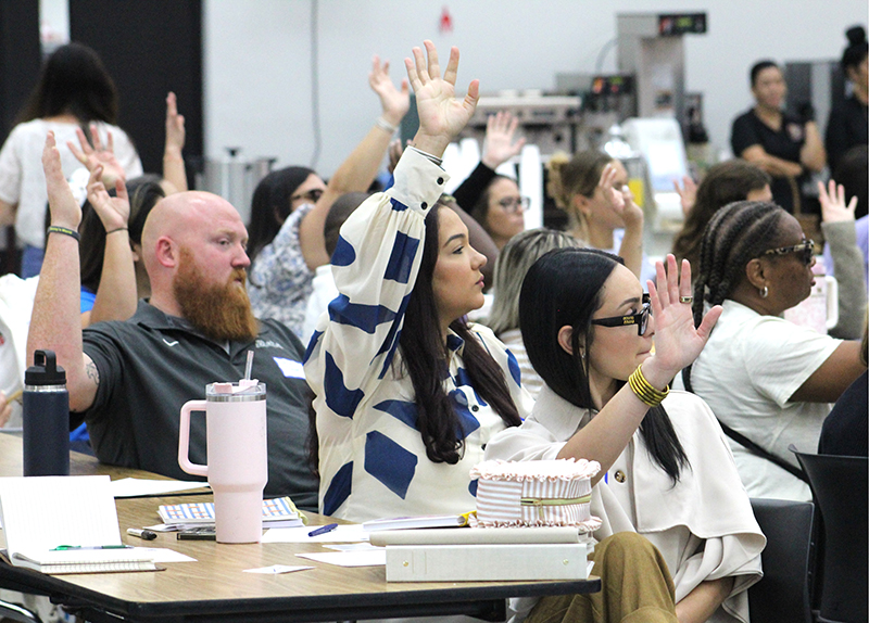 Educators raise their hands during the New Teacher Orientation hosted Aug. 4, 2026 at Monsignor Edward Pace High, in Miami Gardens. Nearly 250 new Archdiocese of Miami educators participated in the half-day event organized by the Office of Catholic Schools.