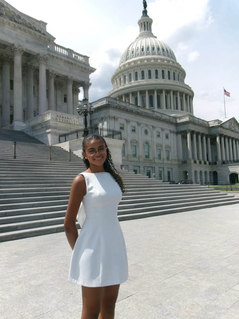 Immaculata-La Salle High School (ILS) graduate Camila Garcia is the first student from ILS to win the Congressional Art Competition, taking first place for Florida's 27th Congressional District with her charcoal portrait "Old Man." She is pictured here in front of the United States Capitol in Washington, D.C., after a reception at the Congressional Visitor Center June 25, 2026, where she was recognized among the national winners.