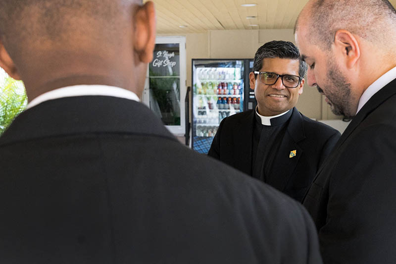 At center, Father Milton Martinez, Archdiocese of Miami vocations director, speaks with seminarians enrolled at St. John Vianney College Seminary in Miami. They gathered Aug. 1, 2026, for a Saturday Vigil Mass at St. Hugh Parish in Coconut Grove as part of their summer convocation and orientation process before the start of the 2026-2027 academic year.