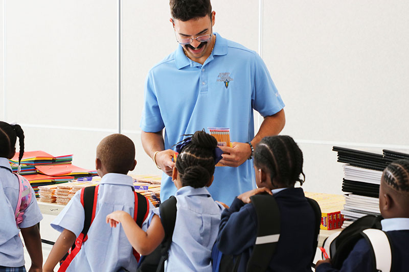 At center, Eddie Tejedor, a volunteer with the Kiwanis of Little Havana Foundation, distributes school supplies at St. Mary’s Cathedral School in Miami Aug. 18, 2026. The Archdiocese of Miami was a sponsor for Kiwanis of Little Havana's Back-to-School Project, which provided school supplies for students in underprivileged communities this August.