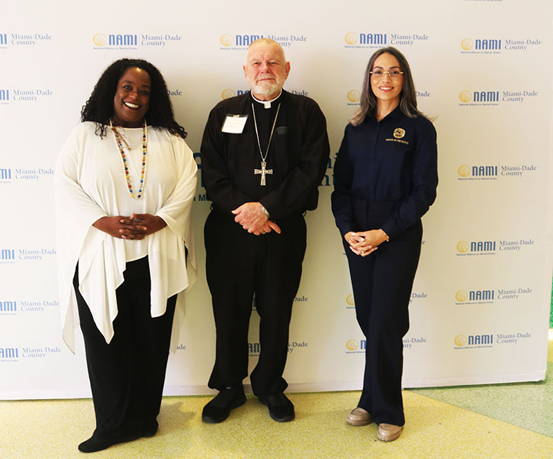 Archbishop Thomas Wenski of Miami, center, presented the keynote speech Aug. 21, 2026, at the Pathways to Hope Conference in Miami. The archbishop is pictured with representatives from Miami-Dade County’s Office of the Mayor Daniella Levine Cava: Michelle Johnson (at left), faith and community leadership manager, and Brenda Lampon, senior advocate for older adults, mental health and disabilities.