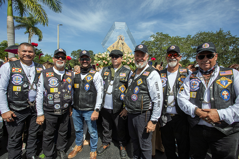 Members of Knights on Bikes Florida gather around the pilgrim image of Our Lady of Charity during its visit to St. Martin de Porres Parish in Leisure City Aug. 22, 2026. The Catholic motorcycle group, whose members are Knights of Columbus, escorted the image during the 35-mile motorcade procession through Miami-Dade County.