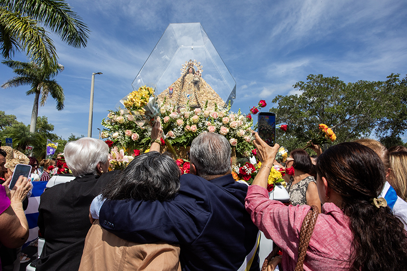 Marixa and Fernando Tara gather in devotion during the visit of the pilgrim image of Our Lady of Charity to St. Martin de Porres Parish in Leisure City Aug. 22, 2026. The parish was the eighth of nine stops during a 35-mile motorcade procession through Miami-Dade County.