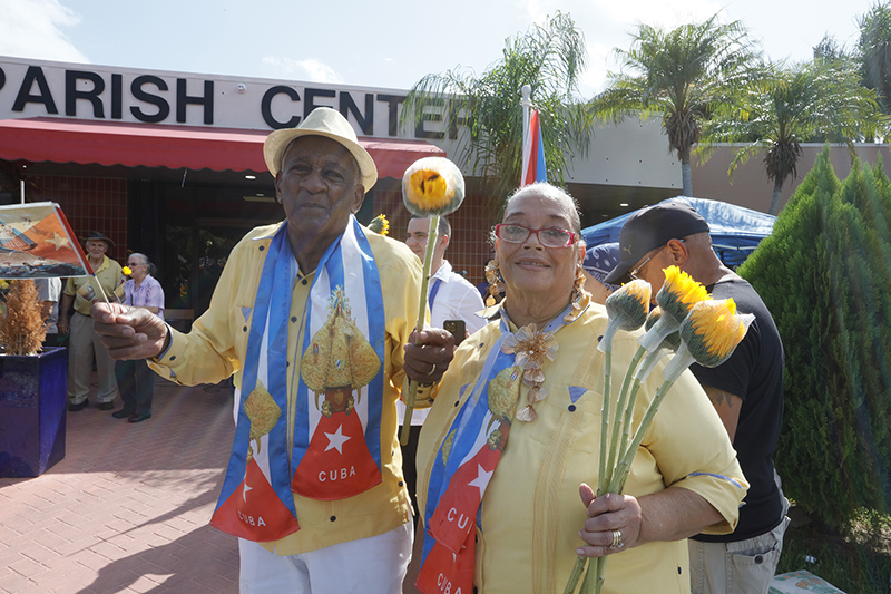 Andy and Wilma Pozo gather with the faithful to welcome the pilgrim image of Our Lady of Charity at Sacred Heart Parish in Homestead Aug. 22, 2026, the final stop of a 35-mile motorcade procession through Miami-Dade County. Parishioners welcomed the image – a symbol of the Virgin Mary’s presence in South Florida – with prayers, rosaries, flowers and Cuban flags.