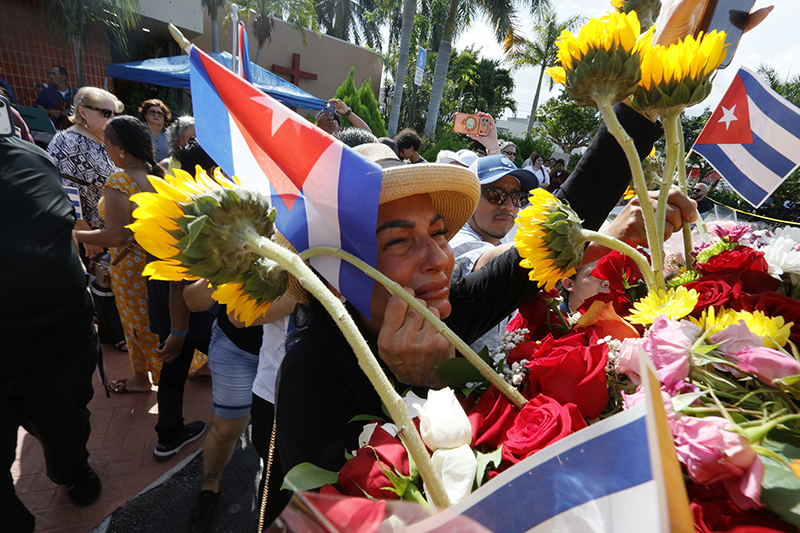 Julia Rivero prays emotionally during the visit of the pilgrim image of Our Lady of Charity to Sacred Heart Parish in Homestead Aug. 22, 2026, the final stop of a 35-mile motorcade procession through Miami-Dade County.