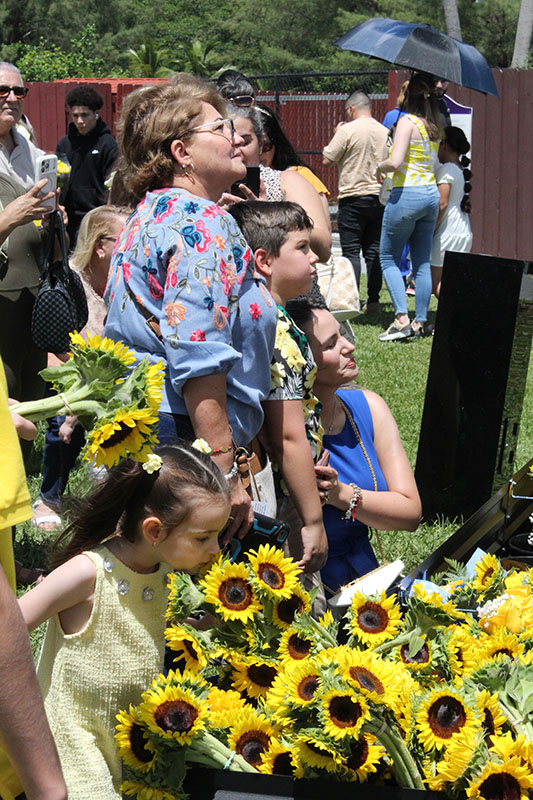 Pilgrims placed flowers near the image of the Virgin Mary at the National Shrine of Our Lady of Charity in Miami on Sept. 7, 2026. Our Lady of Charity is known as the patroness of Cuba, and many Cubans living in Miami maintain a devotion, with thousands visiting the shrine year-round, especially during the days leading to her annual feast day, Sept. 8.