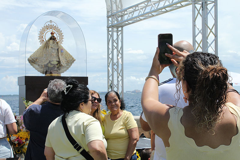 Pilgrims take photos with an image of the Virgin Mary at the National Shrine of Our Lady of Charity in Miami on Sept. 7, 2026. Our Lady of Charity is known as the patroness of Cuba, and many Cubans living in Miami maintain a devotion, with thousands visiting the shrine year-round, especially during the days leading to her annual feast day, Sept. 8.