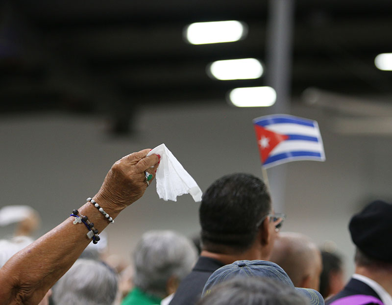 Attendees wave handkerchiefs and Cuban flags to celebrate the entrance of the statue of Our Lady of Charity, a symbol of Mary’s enduring love, during the Our Lady of Charity feast day celebration Sept. 8, 2026, at Miami-Dade Fair and Exposition.