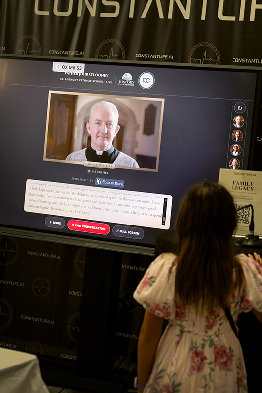 During the centennial festivities at St. Anthony Catholic School in Fort Lauderdale Sept. 13, 2026, guests encounter an AI-generated avatar likeness of the late Father John O’Looney, who was first appointed pastor of the parish in 1929.