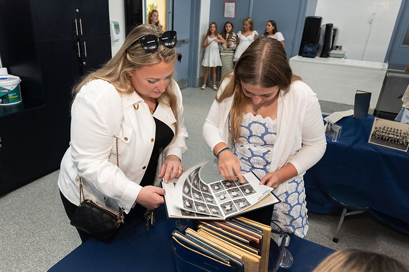 Guests take a trip down memory lane through a display of memorabilia at St. Anthony Catholic School Sept. 13, 2026, during the official launch of the Fort Lauderdale school’s yearlong Centennial Celebration.