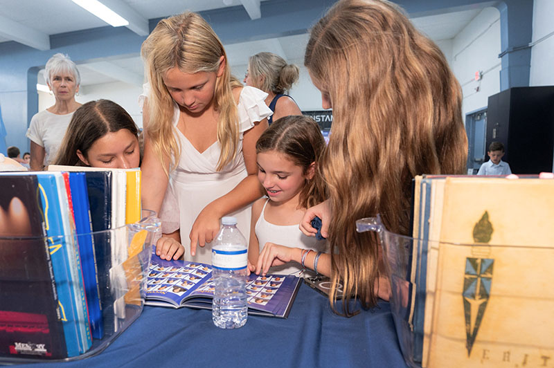 Guests take a trip down memory lane through a display of memorabilia at St. Anthony Catholic School Sept. 13, 2026, during the official launch of the Fort Lauderdale school’s yearlong Centennial Celebration.
