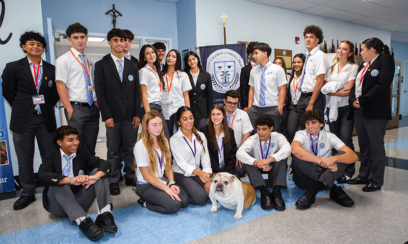 The Archbishop Coleman F. Carroll High School journalism class poses for a photo with Archie the bulldog Aug. 27, 2026. The four-legged mascot has been a beloved member of the Miami school for over a decade.