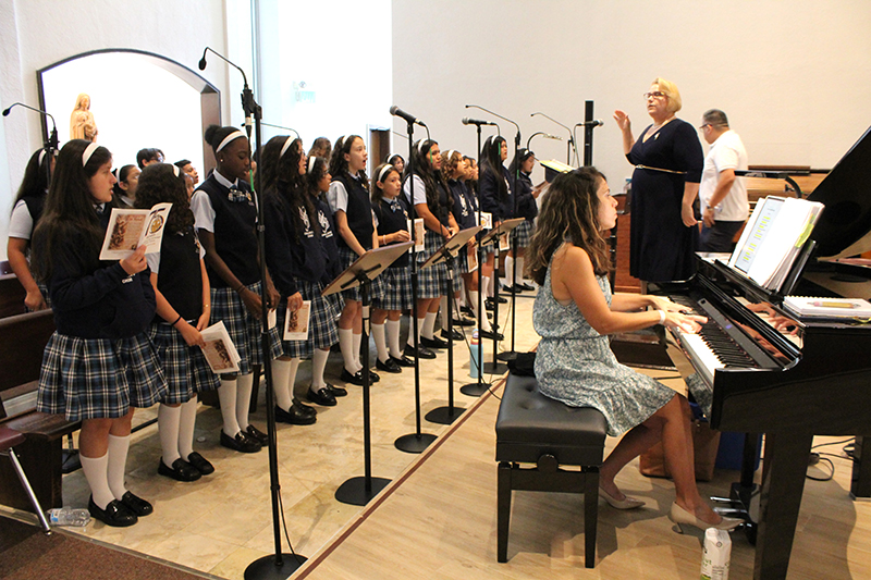 The St. Michael the Archangel School choir rehearses prior to the Miami school's 75th anniversary Mass, celebrated by Archbishop Thomas Wenski, Sept. 20, 2026 at St. Michael the Archangel Parish.