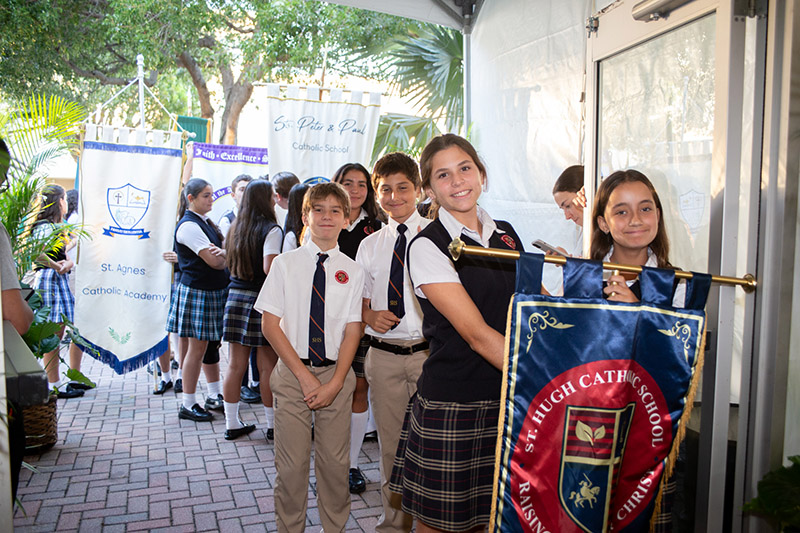 Students from St. Agnes Catholic Academy in Key Biscayne, Sts. Peter and Paul School in Miami, and St. Hugh School in Coconut Grove prepare to carry their banners during the entrance procession during the Feast of Our Lady of Mercy Mass Sept. 24, 2026, at HCA Florida Mercy Hospital in Miami. A total of six Archdiocese of Miami schools carried banners during the community event.