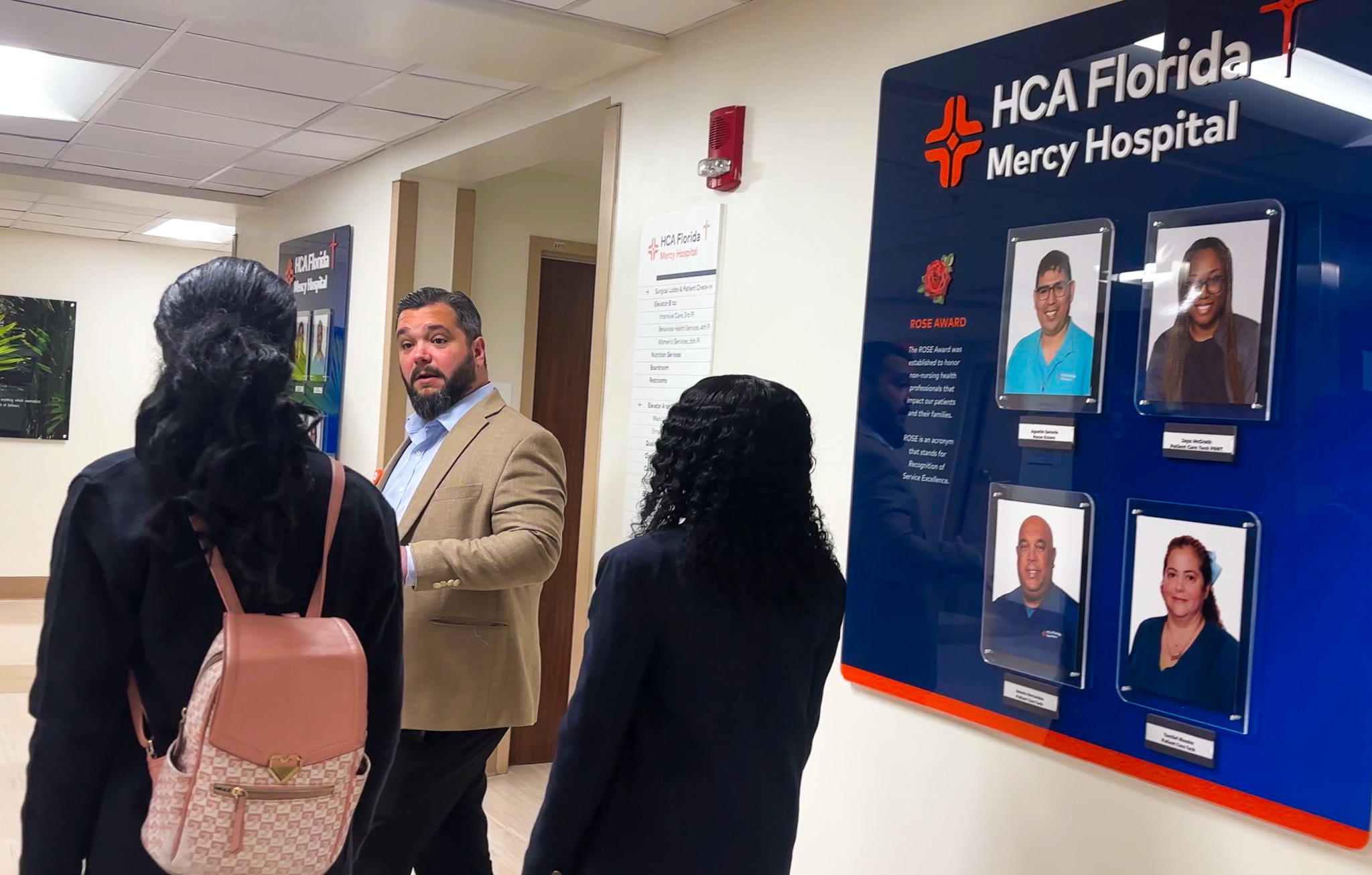 Henry Garcia, vice president of mission integration at HCA Florida Mercy Hospital in Miami, gives Cristo Rey Miami High School ninth-graders Nailah Civil and Marcelinesarah Senecharles a tour of their new workplace Aug. 14, 2026. (COURTESY)