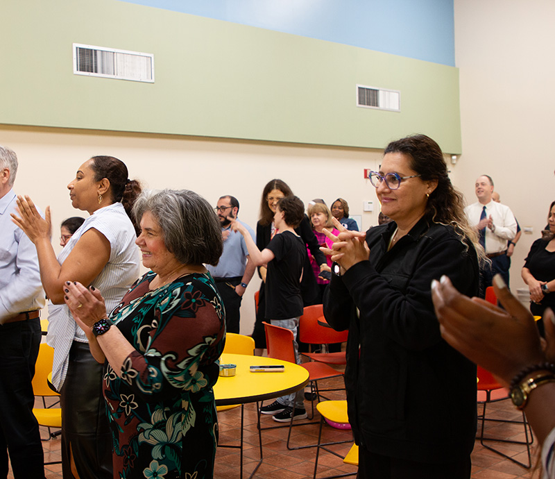 Employees of the Archdiocese of Miami Pastoral Center in Miami Shores clap for Archbishop Thomas Wenski during his 76th birthday party on Oct. 28, 2026.