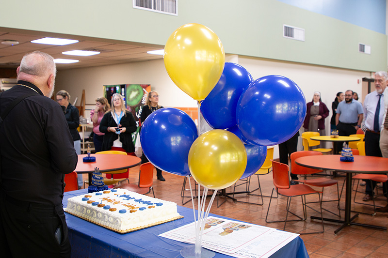 Miami Archbishop Thomas Wenski, at left, says a few words before cutting the cake at his 76th birthday festivities Oct. 28, 2026, at the Archdiocese of Miami Pastoral Center in Miami Shores.